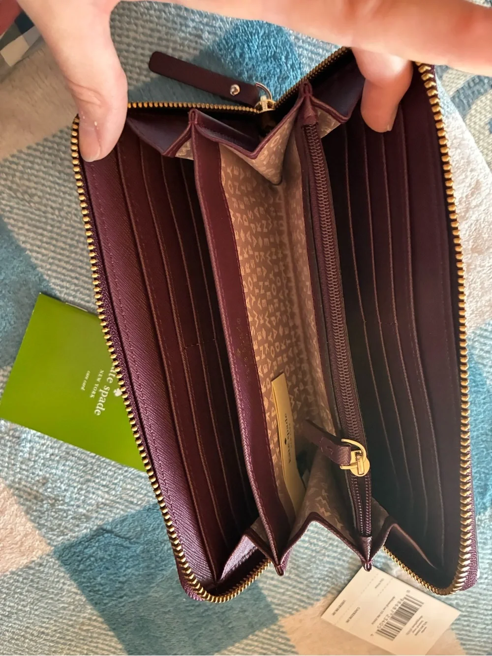 kate spade plum/burgundy zip-around card wallet with gold logo